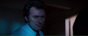 Movie still from “Magnum Force” (1973), directed by Ted Post – A person wearing a shirt and a tie; Close Up shot, Over the shoulder angle