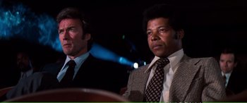 Movie still from “Magnum Force” (1973), directed by Ted Post – A man in a suit and tie next to another man in a suit and tie; Close Up shot, Low angle