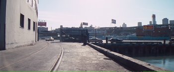 Movie still from “Magnum Force” (1973), directed by Ted Post – Cars are parked on the side of the road; Extreme Wide shot, High angle