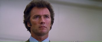 Movie still from “Magnum Force” (1973), directed by Ted Post – A person wearing a suit and tie; Close Up shot, Low angle
