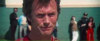 Movie still from “Magnum Force” (1973), directed by Ted Post – A person wearing a red shirt; Close Up shot, Over the shoulder angle