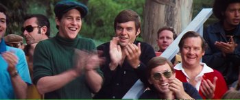 Movie still from “Magnum Force” (1973), directed by Ted Post – A group of men sitting next to each other in a park; Medium shot, Over the shoulder angle