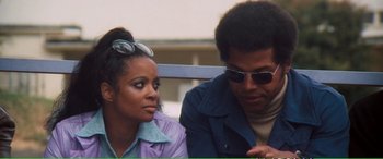 Movie still from “Magnum Force” (1973), directed by Ted Post – A man and a woman sitting next to each other on a bench; Close Up shot, Over the shoulder angle