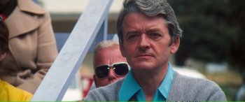 Movie still from “Magnum Force” (1973), directed by Ted Post – An older man wearing sunglasses; Close Up shot, Low angle