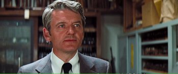 Movie still from “Magnum Force” (1973), directed by Ted Post – An older man in a suit and tie looking to his left; Close Up shot, Low angle