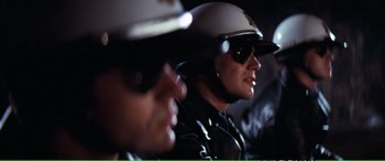 Movie still from “Magnum Force” (1973), directed by Ted Post – Two police officers wearing helmets and sunglasses; Close Up shot, Low angle