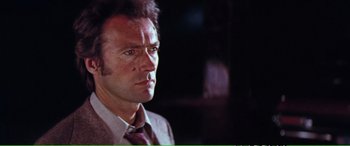 Movie still from “Magnum Force” (1973), directed by Ted Post – A person wearing a suit and tie; Close Up shot, Low angle