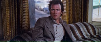 Movie still from “Magnum Force” (1973), directed by Ted Post – A person wearing a suit and tie; Close Up shot, Over the shoulder angle