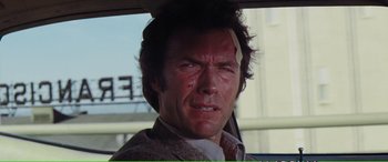Movie still from “Magnum Force” (1973), directed by Ted Post – A man with a bandage on his head; Close Up shot, Over the shoulder angle