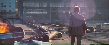 Movie still from “Magnum Force” (1973), directed by Ted Post – A woman standing in front of a pile of logs; Wide shot, Low angle