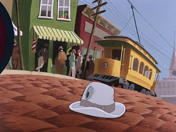 Movie still from “Make Mine Music” (1946), directed by Hamilton Luske – A cartoon of a hat sitting on the ground in front of a train station; Wide shot, Low angle