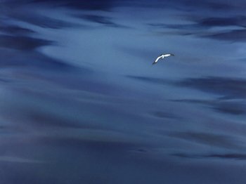 Movie still from “Make Mine Music” (1946), directed by Hamilton Luske – A bird flying over a body of water; Extreme Wide shot, High angle