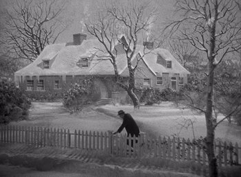 Movie still from “Make Way for Tomorrow” (1937), directed by Leo McCarey – An old black and white photo of a man riding a bike through the snow; Extreme Wide shot, High angle