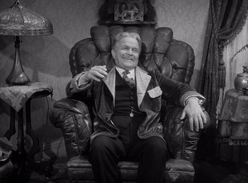Movie still from “Make Way for Tomorrow” (1937), directed by Leo McCarey – An older man sitting in a leather chair; Medium shot, High angle