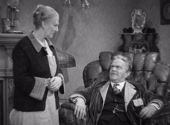 Movie still from “Make Way for Tomorrow” (1937), directed by Leo McCarey – An older man sitting in a chair next to an older woman; Medium shot, High angle