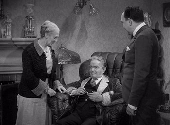 Movie still from “Make Way for Tomorrow” (1937), directed by Leo McCarey – An older man and a younger man in a suit and tie; Medium shot, High angle