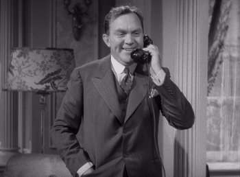 Movie still from “Make Way for Tomorrow” (1937), directed by Leo McCarey – A man in a suit talking on a phone; Medium shot, High angle