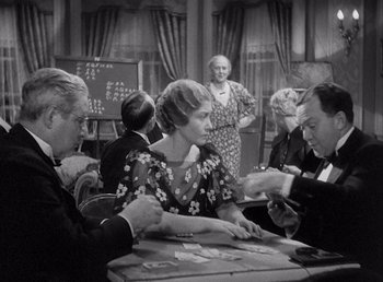 Movie still from “Make Way for Tomorrow” (1937), directed by Leo McCarey – A group of people sitting at a table playing cards; Medium shot, Over the shoulder angle