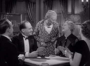 Movie still from “Make Way for Tomorrow” (1937), directed by Leo McCarey – A group of people sitting at a table with playing cards; Medium shot, High angle
