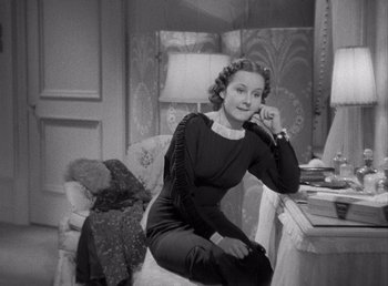 Movie still from “Make Way for Tomorrow” (1937), directed by Leo McCarey – An old photo of a woman sitting on a chair in a room; Medium shot, High angle