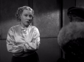 Movie still from “Make Way for Tomorrow” (1937), directed by Leo McCarey – A black and white photo of a woman standing in front of a mirror; Medium shot, Over the shoulder angle