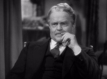 Movie still from “Make Way for Tomorrow” (1937), directed by Leo McCarey – An older man wearing a suit and tie sitting in a chair with his hand under his chin; Close Up shot, Over the shoulder angle