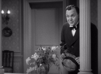 Movie still from “Make Way for Tomorrow” (1937), directed by Leo McCarey – An old photo of a man in a suit holding a hat; Medium shot, Over the shoulder angle