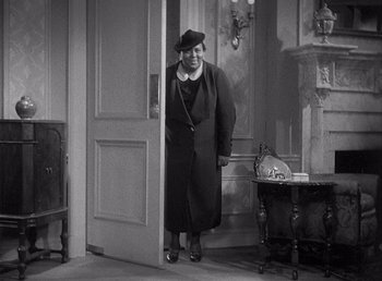 Movie still from “Make Way for Tomorrow” (1937), directed by Leo McCarey – An old photo of a woman standing in front of an open door; Medium shot, High angle