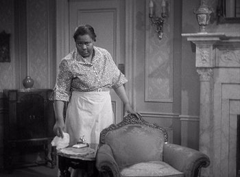 Movie still from “Make Way for Tomorrow” (1937), directed by Leo McCarey – A woman in an old fashioned living room setting; Medium shot, High angle
