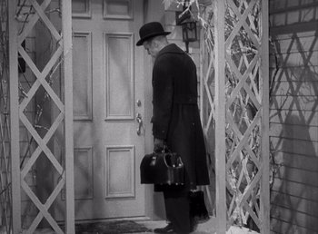 Movie still from “Make Way for Tomorrow” (1937), directed by Leo McCarey – An older man in a hat and coat holding a purse; Medium shot, High angle