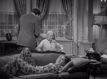 Movie still from “Make Way for Tomorrow” (1937), directed by Leo McCarey – An older woman laying on a couch next to two men; Wide shot, High angle