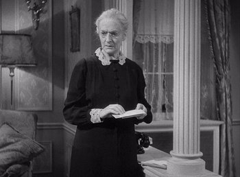 Movie still from “Make Way for Tomorrow” (1937), directed by Leo McCarey – An older woman in a black dress holding a book; Medium shot, Over the shoulder angle