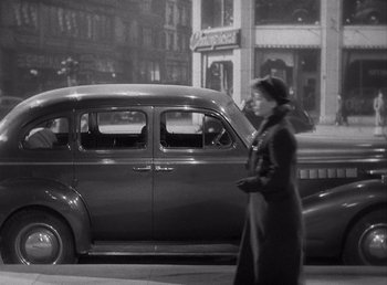 Movie still from “Make Way for Tomorrow” (1937), directed by Leo McCarey – A woman walking down the street in front of an old car; Wide shot, Low angle