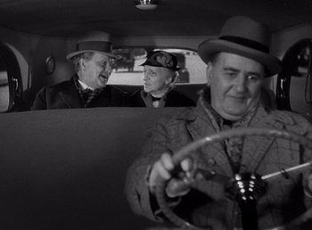 Movie still from “Make Way for Tomorrow” (1937), directed by Leo McCarey – A group of men sitting in the back seat of a car; Medium shot, Over the shoulder angle