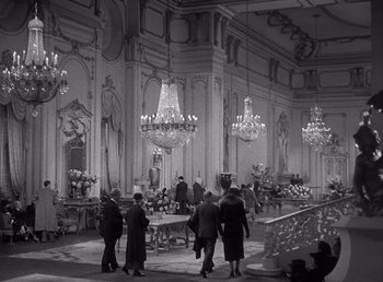 Movie still from “Make Way for Tomorrow” (1937), directed by Leo McCarey – A black and white photo of people in a large room; Extreme Wide shot, High angle