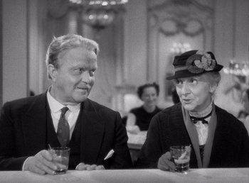 Movie still from “Make Way for Tomorrow” (1937), directed by Leo McCarey – A man and a woman sitting at a table with drinks; Medium shot, Over the shoulder angle