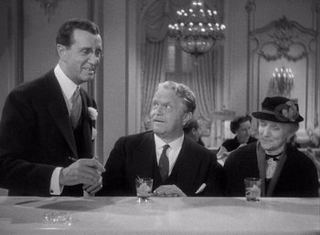 Movie still from “Make Way for Tomorrow” (1937), directed by Leo McCarey – A group of men sitting at a table with drinks; Medium shot, Over the shoulder angle