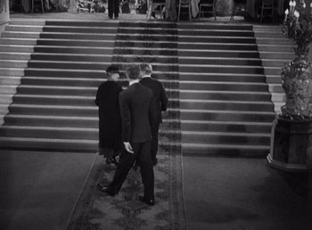 Movie still from “Make Way for Tomorrow” (1937), directed by Leo McCarey – Three men in suits are walking down the stairs; Wide shot, High angle