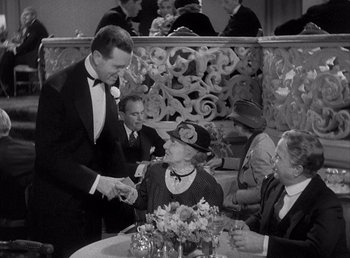 Movie still from “Make Way for Tomorrow” (1937), directed by Leo McCarey – An old photo of a man and a woman at a table; Medium shot, High angle