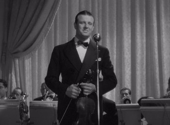 Movie still from “Make Way for Tomorrow” (1937), directed by Leo McCarey – A black and white photo of a man holding a microphone; Medium shot, Low angle