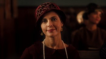 Movie still from “Malcolm X” (1992), directed by Spike Lee – A woman wearing a red hat and a necklace; Close Up shot, Low angle