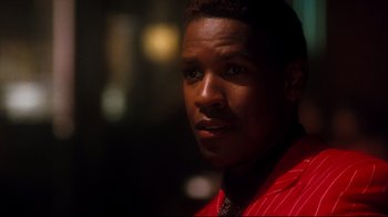 Movie still from “Malcolm X” (1992), directed by Spike Lee – A person wearing a suit and tie; Close Up shot, Over the shoulder angle