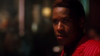 Movie still from “Malcolm X” (1992), directed by Spike Lee – A man in a red jacket is looking at the camera; Close Up shot, Over the shoulder angle