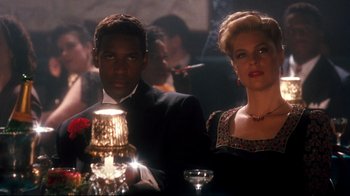 Movie still from “Malcolm X” (1992), directed by Spike Lee – A man and a woman are holding a lit candle; Medium shot, Low angle