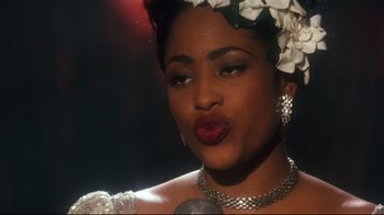 Movie still from “Malcolm X” (1992), directed by Spike Lee – A person with a microphone; Close Up shot, Over the shoulder angle