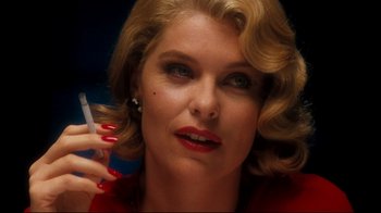 Movie still from “Malcolm X” (1992), directed by Spike Lee – A person talking on a cell phone; Close Up shot, Low angle