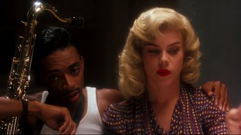 Movie still from “Malcolm X” (1992), directed by Spike Lee – A man and a woman sitting next to each other; Close Up shot, Over the shoulder angle