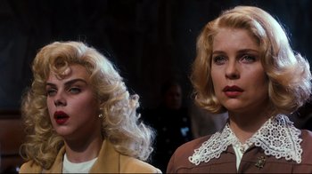 Movie still from “Malcolm X” (1992), directed by Spike Lee – Two blonde women standing next to each other in a room; Close Up shot, Low angle