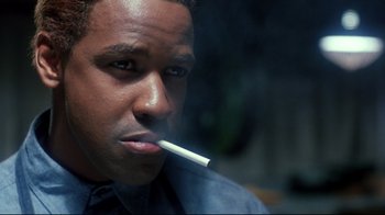 Movie still from “Malcolm X” (1992), directed by Spike Lee – A person with a cigarette in his mouth; Close Up shot, Low angle