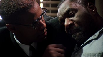 Movie still from “Malcolm X” (1992), directed by Spike Lee – A man and a woman are hugging and looking at each other; Close Up shot, Over the shoulder angle